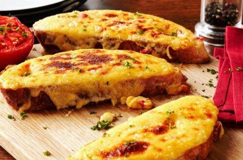 At first glance, Welsh rarebit might look like posh cheese on toast — but don't be fooled. This classic dish is a silky, savoury cheese sauce, often infused with mustard, ale, and a touch of spice, spooned generously over thick-cut toasted bread and grilled until bubbling and golden.